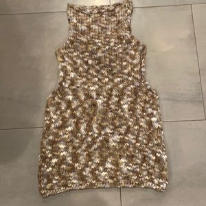 Sweater vest, turtleneck by Maurizio Pecoraro.